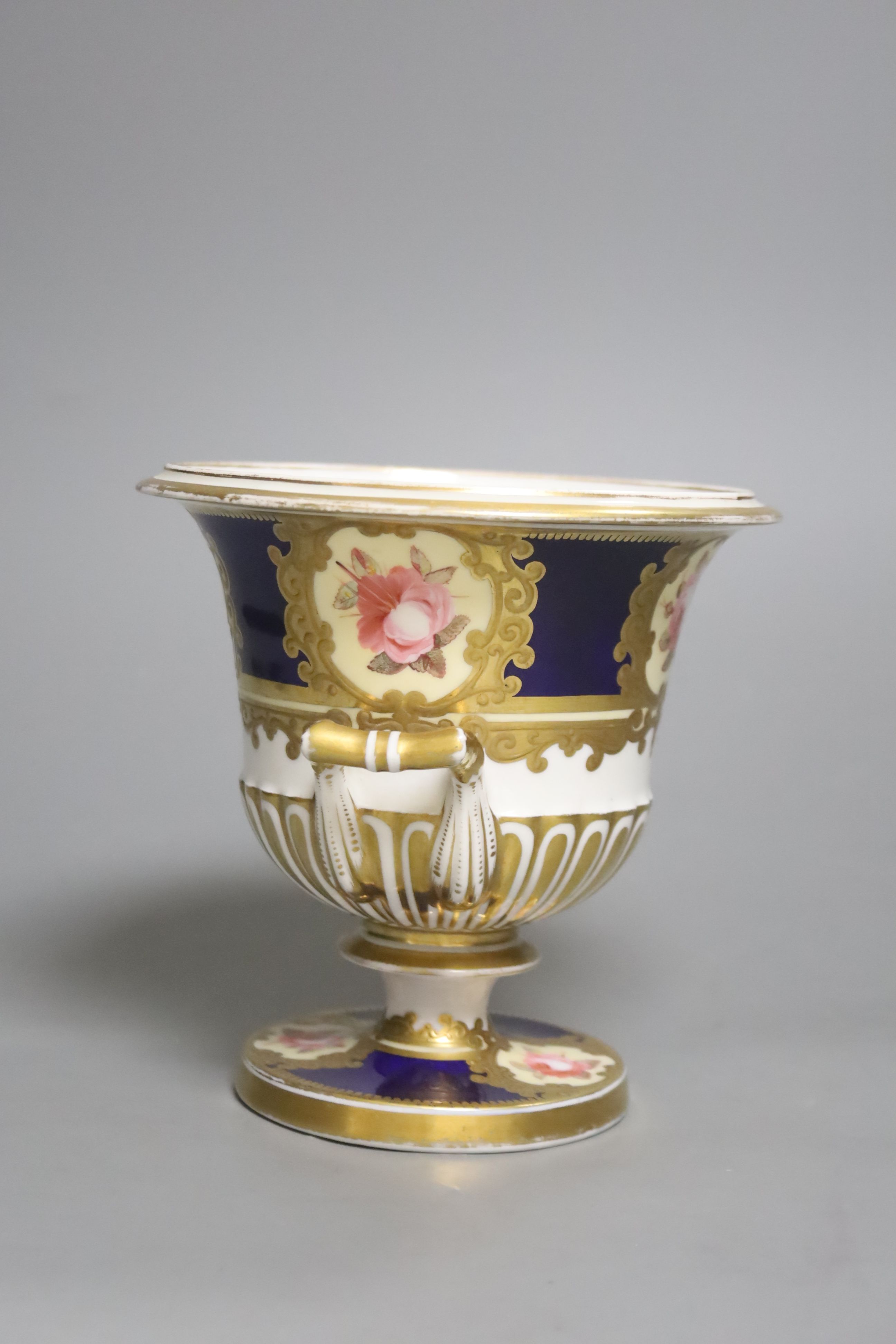 A Chamberlains Worcester two handled vase, painted with six single roses on a blue ground, height 14.5cm